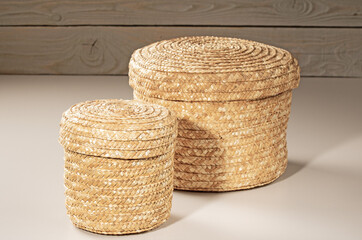two baskets woven from rattan for storing household items.