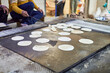 Making of chapati round flatbreads for langar in sikh gurudwara temple many uncooked roti flatbreads