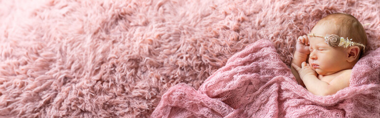 Poster - newborn baby sleeping on a pink background. selective focus.