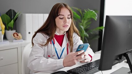 Poster - Young hispanic woman doctor using computer and smartphone at clinic