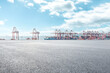 © zhao dongfang - Empty asphalt road and container port background