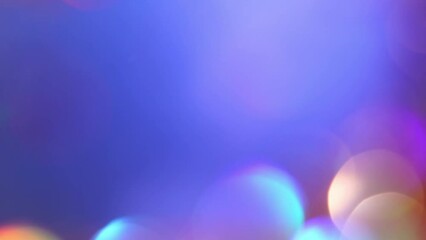 Wall Mural - Golden bokeh motion on blue background with copy space. Gentle shimmers of shiny sparkling defocused blurry circles. Abstract Christmas Bokeh Background. 