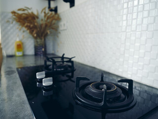 Wall Mural - Modern gas stove built into a black table in the kitchen.