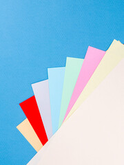 Poster - Colorful paper sheet background  isolated on blue, close up