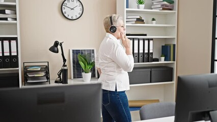 Poster - Middle age grey-haired woman business worker having free hands call at office