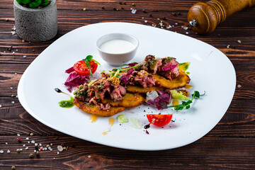 Sticker - Potato pancakes with beef, Dijon mustard, tomatoes, lettuce and sour cream, lunch.