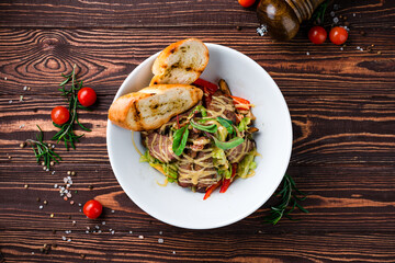 Poster - Salad with beef slices, sweet pepper, lettuce, greens and fried toasts.