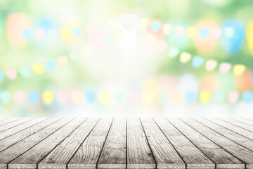 Empty wooden table with party in garden background blurred.