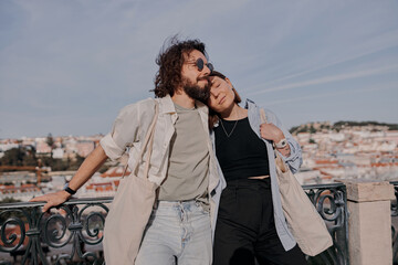 Smiling Tourist couple in love cuddling on old Lisbon street. Travel And tourism In Europe concept