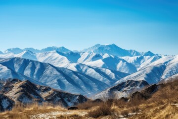 Wall Mural - majestic mountain range with snow-capped peaks and crystal blue skies, created with generative ai