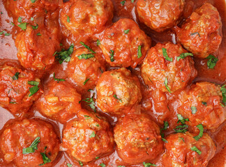 Wall Mural - Texture of tasty meat balls with tomato sauce and parsley, closeup