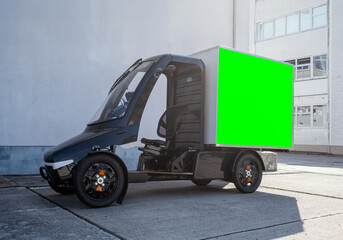 A modern electric delivery 4-wheel Quadracycle bike with a blank white cargo box with copy space for advertising.