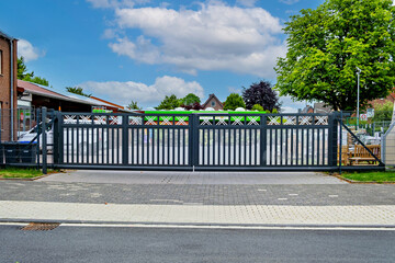 Sticker - A gray sliding automatic gate on the side of the road in front of a house in Germany