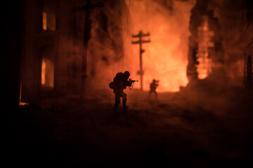 Wall Mural - War Concept. Battle scene on war fog sky background, Fighting silhouettes Below Cloudy Skyline at night. City destroyed by war