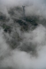 Poster - View of the majestic fog-covered green mountains and winding Transfagarasan road