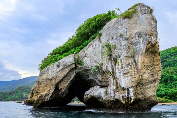 Poster - Majestic stone set in the center of a tranquil body of water of Los Arcos in Puerto Vallarta Mexico