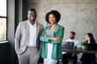 © Prostock-studio - Happy Couple Of Black Coworkers Posing At Modern Office Interior