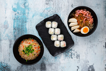 Canvas Print - Rice with chicken, dashi broth and sushi maki rolls with crab sticks.