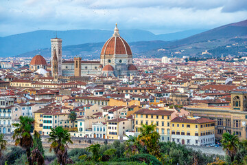 Wall Mural - panoramic view of Firenze (Florence) at sunset, taken from Piazzale Michelangelo.
historical landmarks, including the iconic Duomo and Palazzo Vechio,  can be seen at a distance