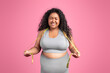 © Prostock-studio - Unhappy sad black plus size woman in sportswear holding measuring tape on neck and crying isolated on pink background