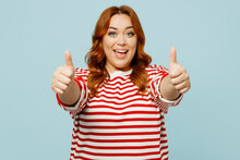 Young Happy Smiling Fun Chubby Overweight Woman Wear Striped Red Shirt Casual Clothes Showing Thumb Up Like Gesture Isolated On Plain Pastel Light Blue Background Studio Portrait. Lifestyle Concept.