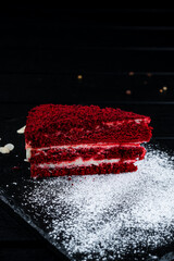 Canvas Print - Piece of red velvet cake with almonds and powdered sugar, fresh dessert.