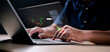 © Garun Studios - Concept Planning and strategy, Stock market, Hands of businessman working at home. Technical price graph and indicator, Red and green candlestick chart and stock trading computer screen.