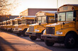 yellow school buses stop at the school and waiting children