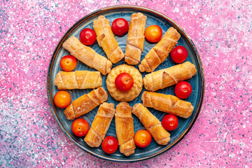 Wall Mural - top view sweet delicious bagels baked pastry inside tray on pink desk bake pastry cake biscuit cookie sweet sugar