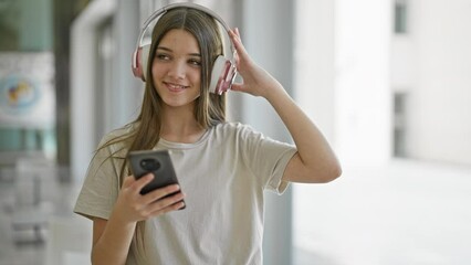 Poster - Young beautiful girl listening to music and dancing at library