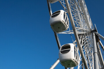 ferris wheel ride in amusement park on blue sky background. High quality photo