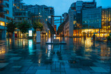 Fototapeta Londyn - Illuminated Akker Brygge, a modern district in Oslo city center at night and in the rain, Norway