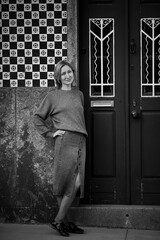 Wall Mural - Woman at the entrance to a traditional house in Portugal. Black and white photo.