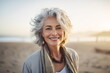 © Canvas Alchemy - Smiling middle age grey-haired woman on the beach