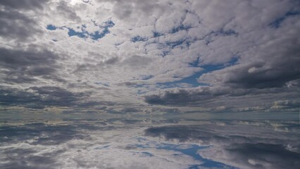 Wall Mural - Water surface in Ultra HD 4K, Loop Footage - View against the sky. sky with evening sky clouds over the sea. Small smooth waves and water reflection
