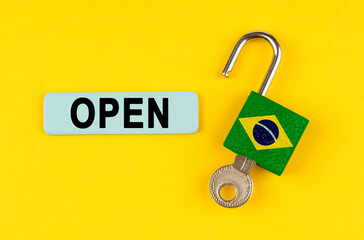 Poster - On the yellow surface is an open lock with a key and a sticker with the inscription - open