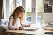 © ADDICTIVE STOCK - A little girl sitting at a desk writing on a piece of paper created with Generative AI technology