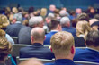 © Nikolay N. Antonov - Rear view of audience in the conference hall or seminar business meeting. Business symposium