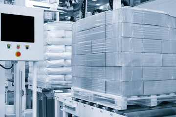 Poster - Cardboard boxes on a pallet wrapped in plastic wrap ready for delivery in a warehouse, logistics warehouse delivery concept background