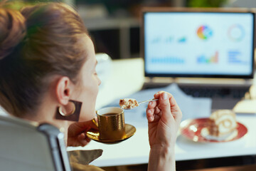 Wall Mural - Closeup on modern female with laptop and piece of cake