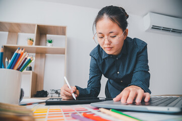 Fototapete - Graphic designer architects who work with laptops and color comparison tables for design work..
