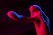 © Михаил Решетников - Woman holding a vibrator in neon pink and blue light.