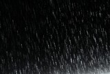 Fototapeta  - Falling rain drops on a black background. Graphic resource for installation or blank for design. AI generated
