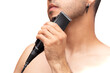© Narayan - man with hair clipper on white background, haircut concept