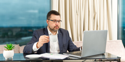 Poster - Happy businessman working on laptop in home office. financial investor working in the office. Accountant working on consolidated financial report of corporate operations.