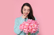© New Africa - Beautiful young woman with bouquet of peonies on pink background
