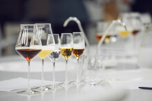 Various alcoholic beverages in glasses in white table in wine room. Sommelier school, professional certification, winemaking association.