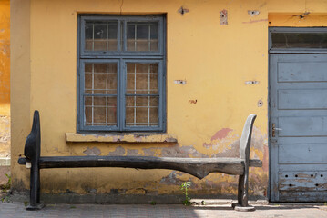 Poster - Bench next to an unrenovated house.