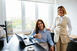 © Westend61 - Happy businesswomen at desk in office