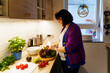 © Westend61 - Pregnant woman with vegetables preparing food at home